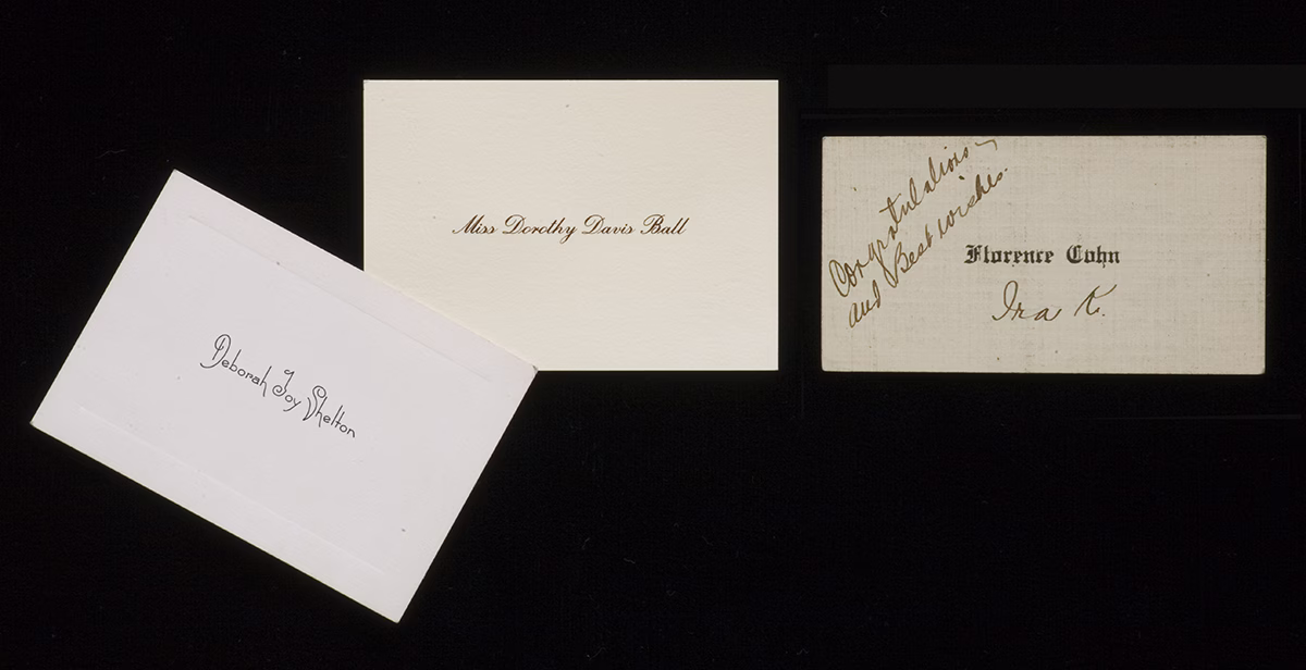 Three historic calling cards. One with a personal message handritten on it.